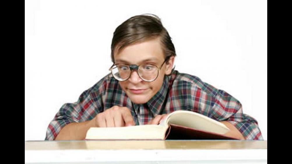 A funny image of a nerdy kid engrossed in studies used as a visual for the post about CAT coaching
