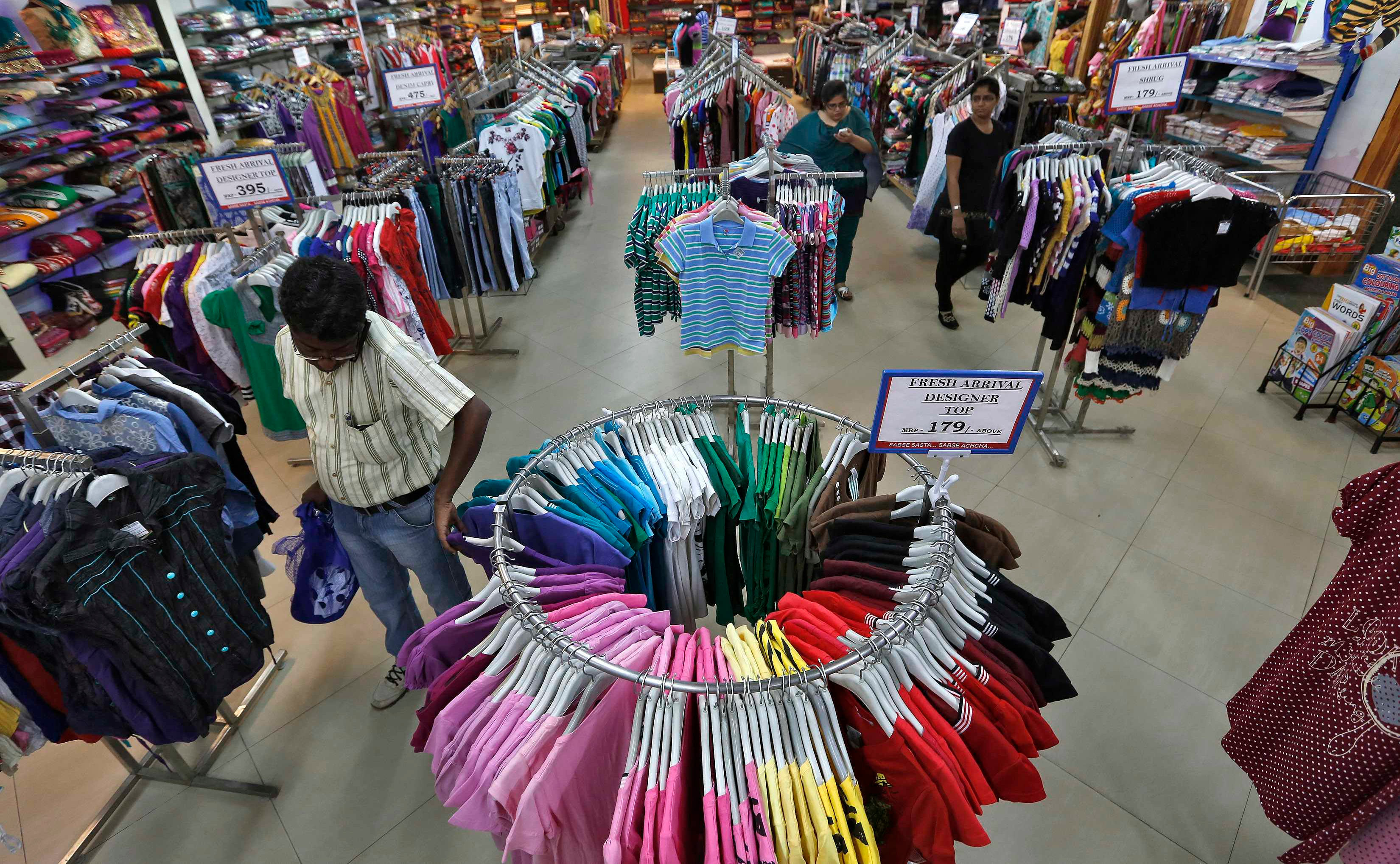 Customers picking clothes in a store used to portray retail management in an article about MBA specialization