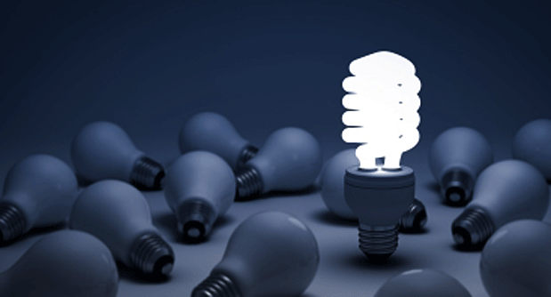 A group of light bulbs, with only one shining brightly, leading the question – “what makes you different?” from the perspective of an MBA interview panel.