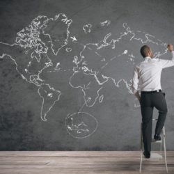 A business drawing world map on a chalkboard, used to depict international business in an article about MBA specialization