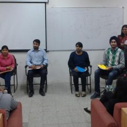Students taking part in a group discussion which is being moderated by a moderator